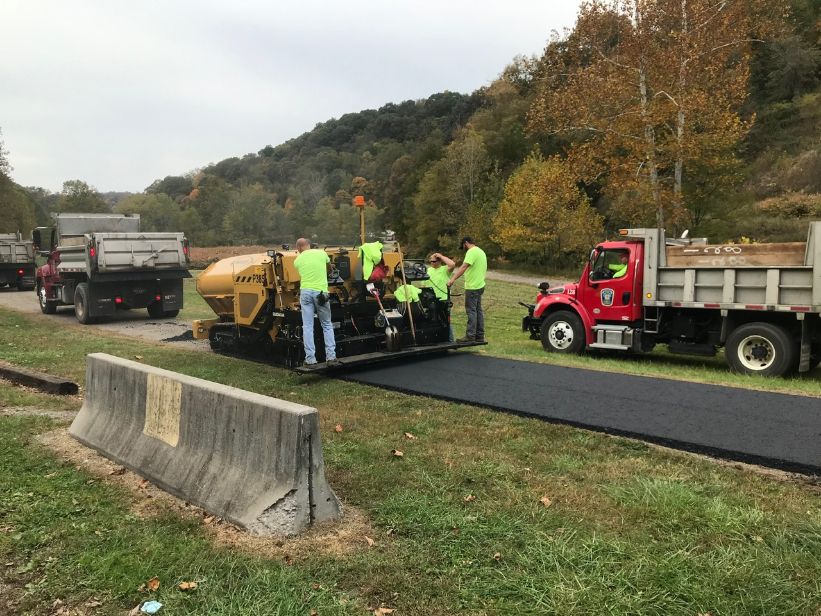 Paver following dump truck at Colliers Station